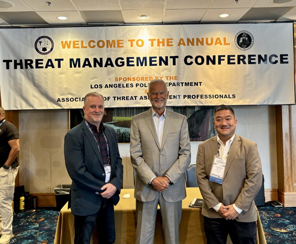 Glenn Sanford, Dr. Meloy and Leonardo Ogihara posing for a picture at the annual Threat Management Conference.