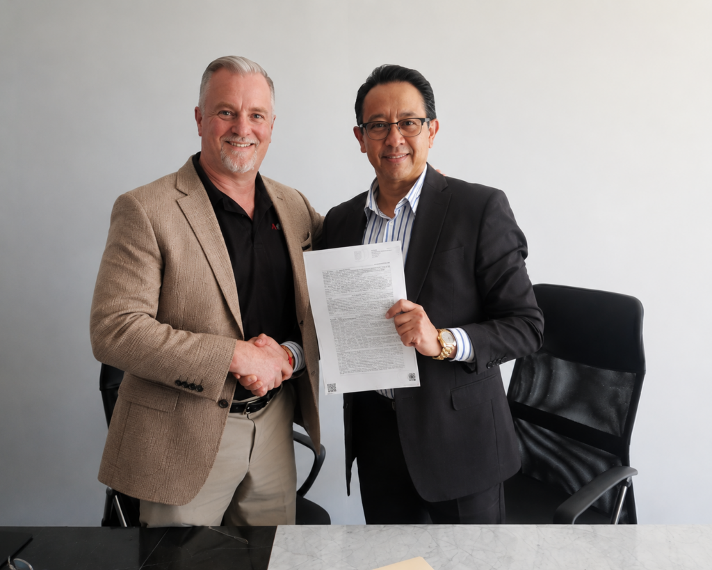 Glenn Sandford and Jose shake hands on the signing of the charter.